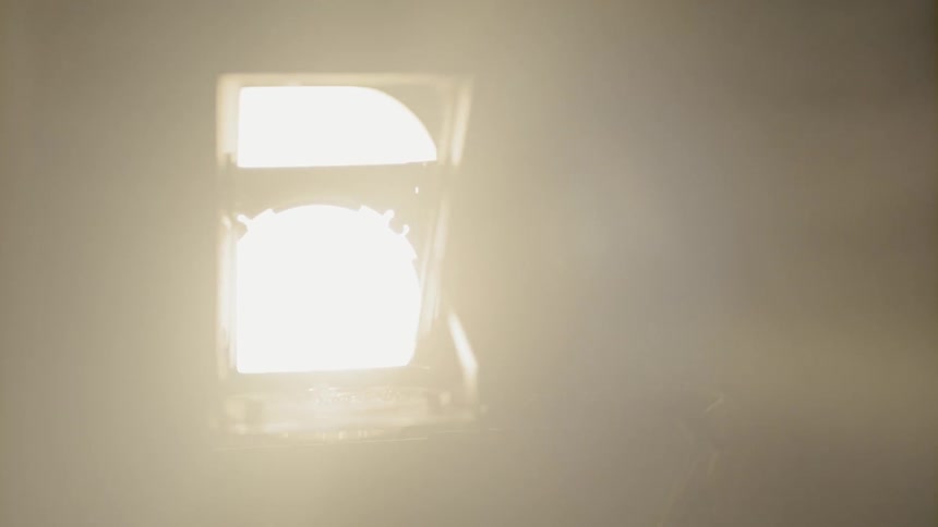 A man takes pictures with a bright light shining