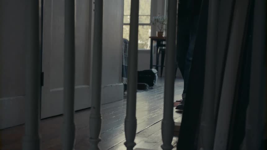 A young man walks through a house