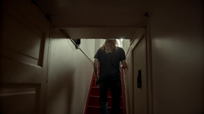 A man walks up the staircase
