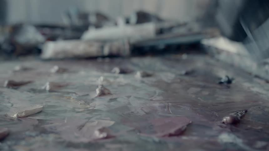 A person wipes paint off a surface