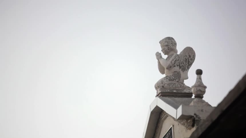 A statue of an angel on top of a building