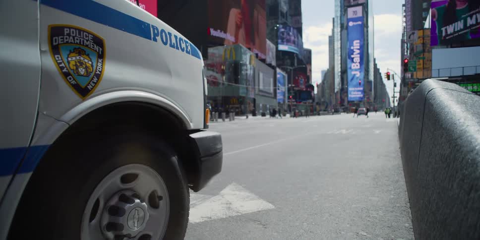 A police van sits next to a curb in new york city