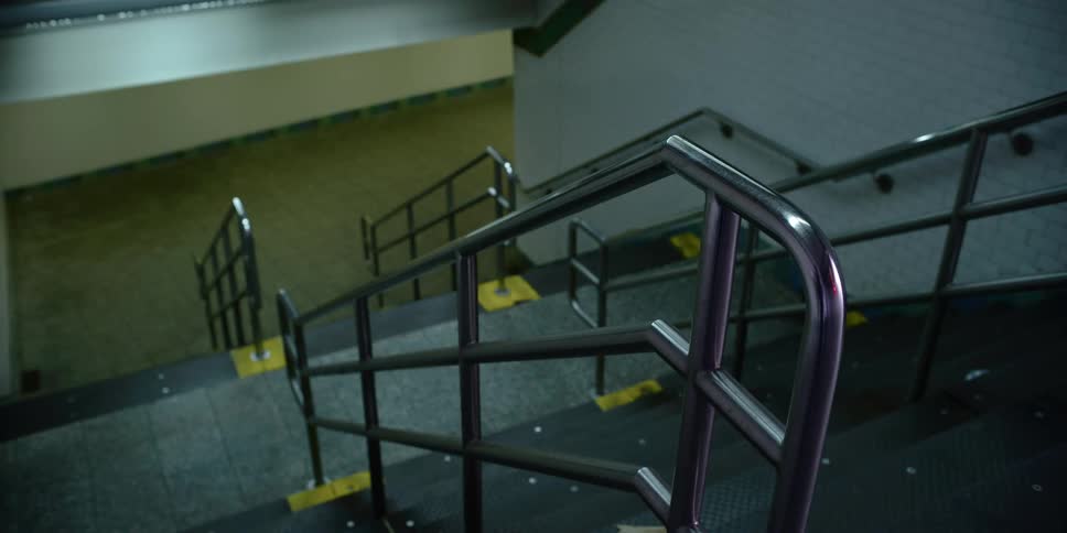 The empty steps and railings leading down to a subway