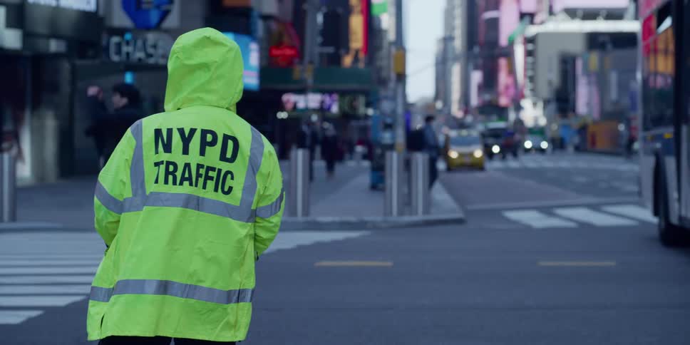 A city traffic cop stands by a road