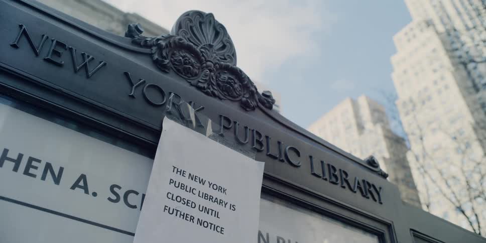 A sign on the side of the library says closed until further notice