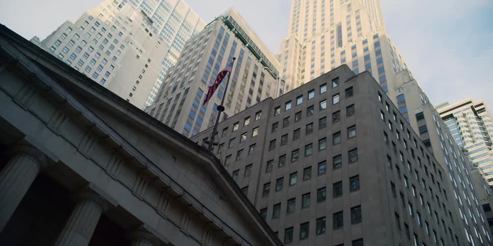A flag flying in the breeze on a building in a city