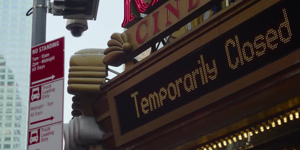 A lit up closed sign on a building