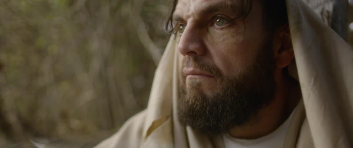 Close up of bearded man face wearing robes