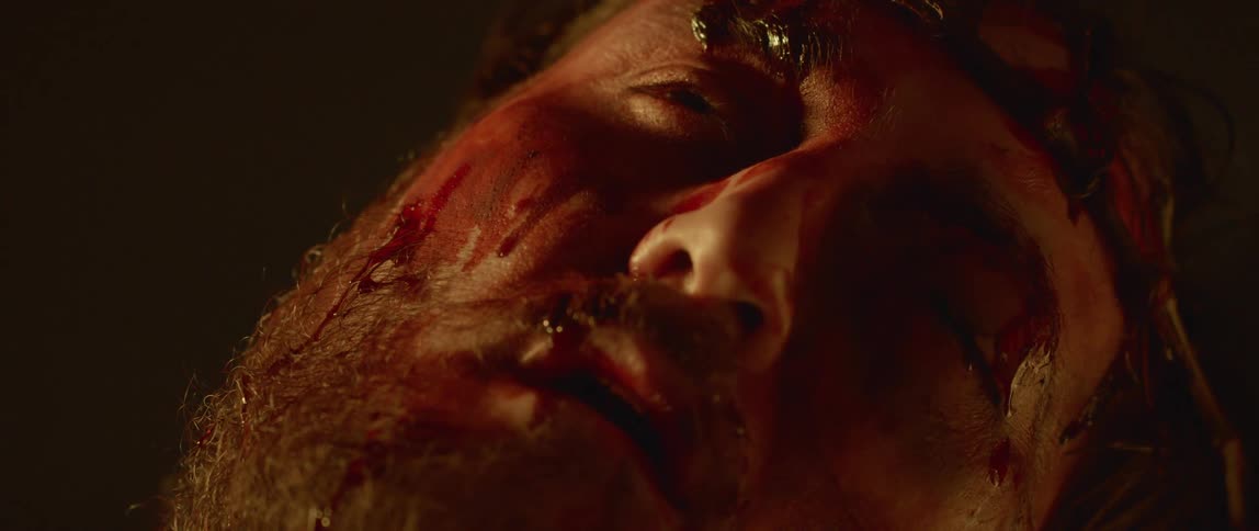 Close up of actor playing jesus christ with bloody face wearing thorn crown