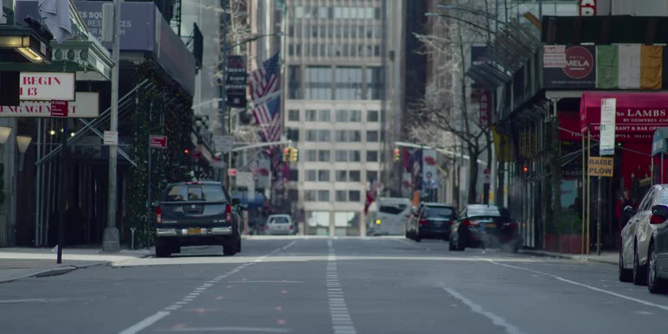 The street is nearly empty in the large city