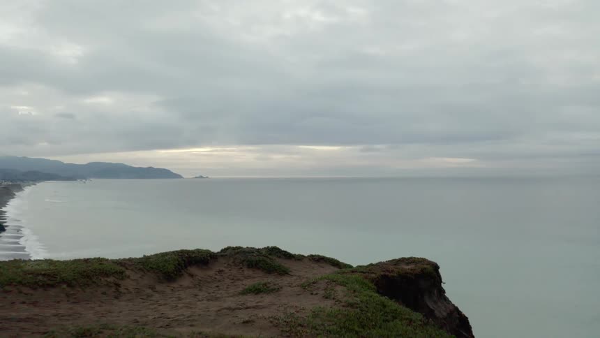 The cliff leads to the vast ocean ahead