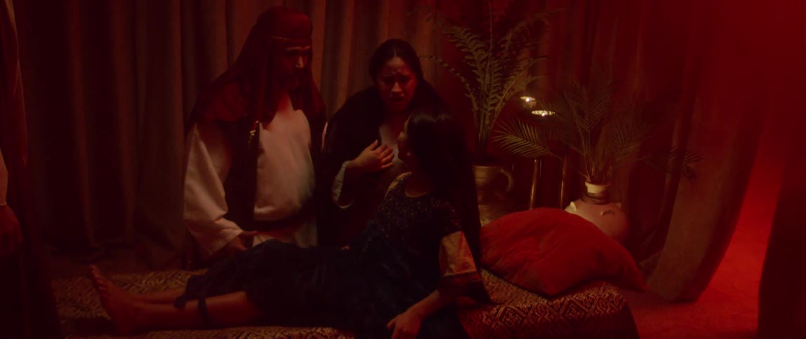 A man and woman cry over their ill daughter and embrace her as she wakes up