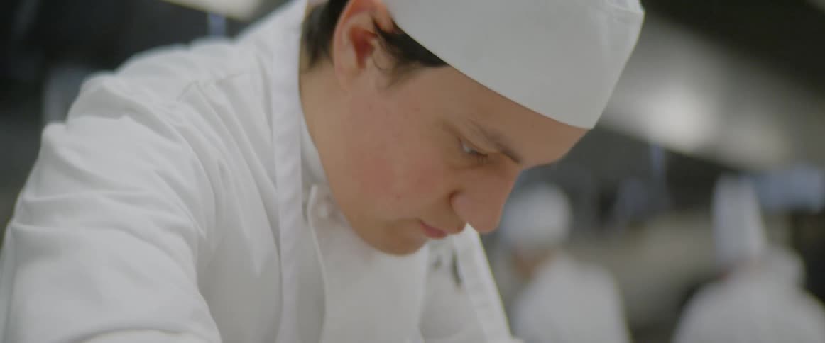 A chef prepares food in a kitchen