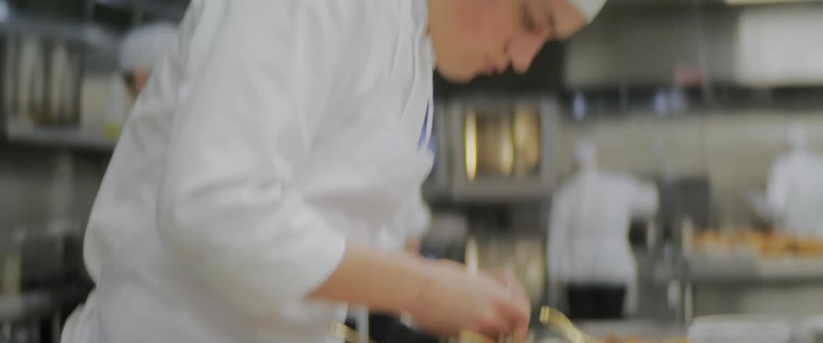 Cooks are preparing meals in a restaurant kitchen