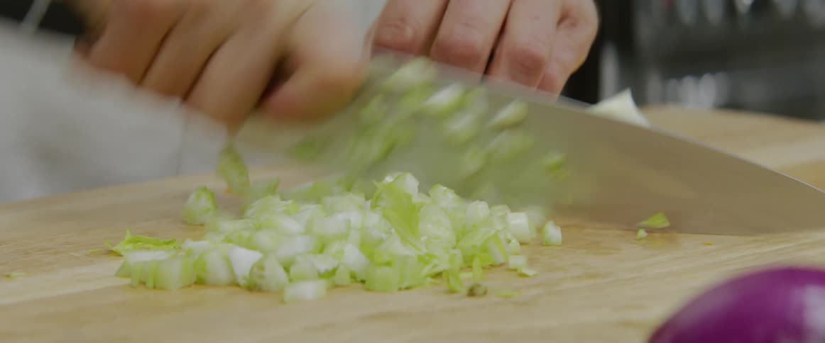A person is cutting celery