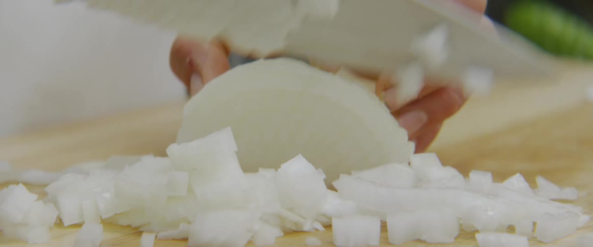 A man chops an onion