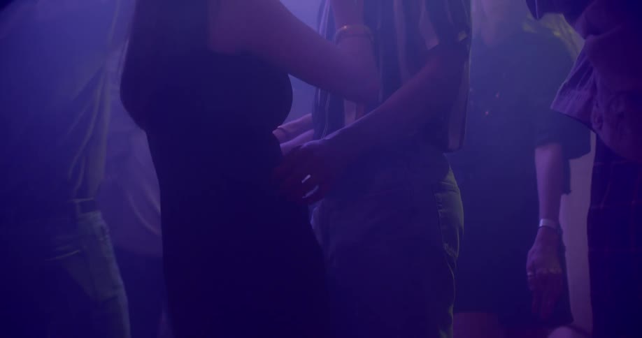 A man and woman dance at a party