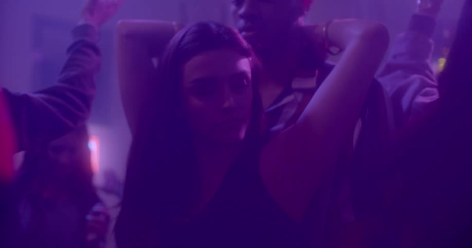 A woman and man dance together at a party
