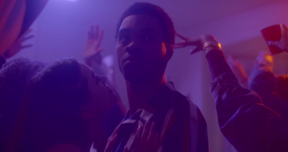 A man and a woman dance at a party