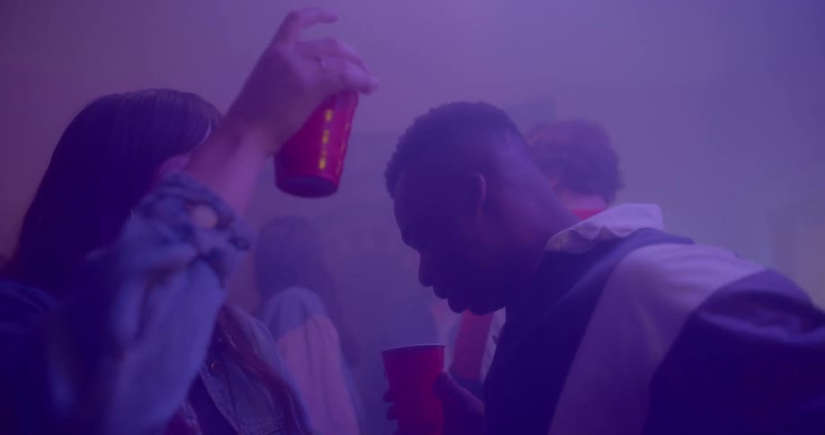 A woman dances with a man at a party