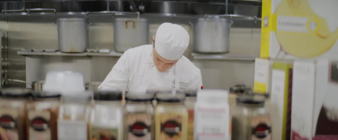 A chef works in a restaurant kitchen
