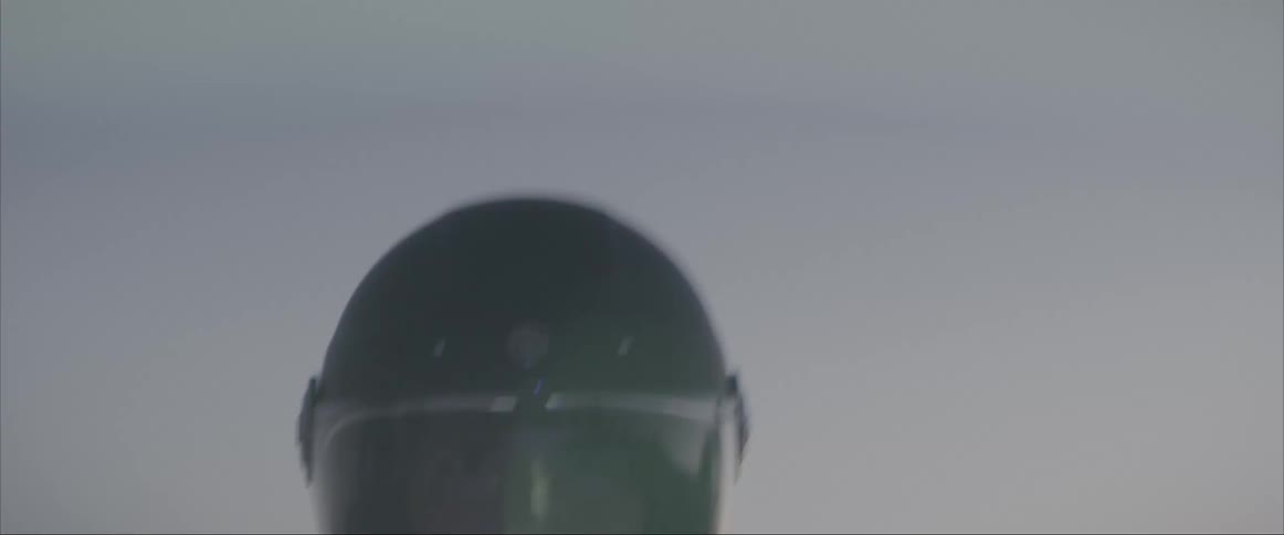A man with a helmet riding a motorcycle