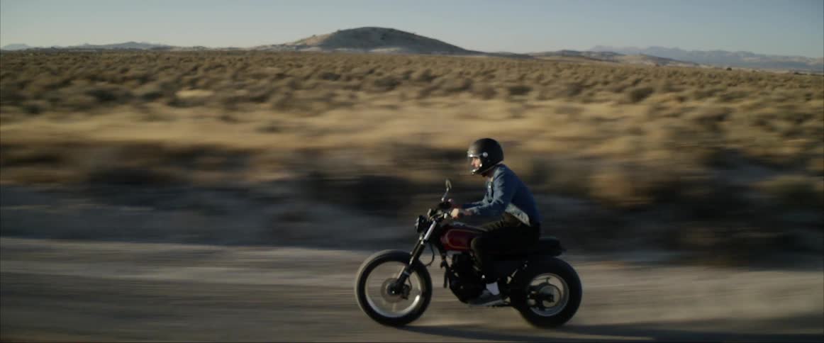 A man riding a motorcycle in the desert