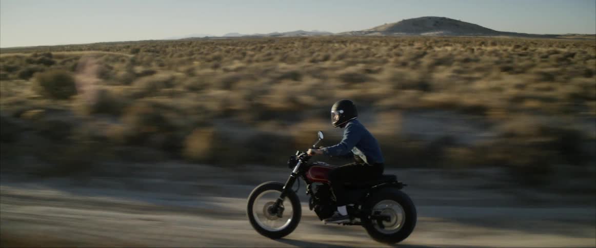 A man riding a motorcycle in the desert