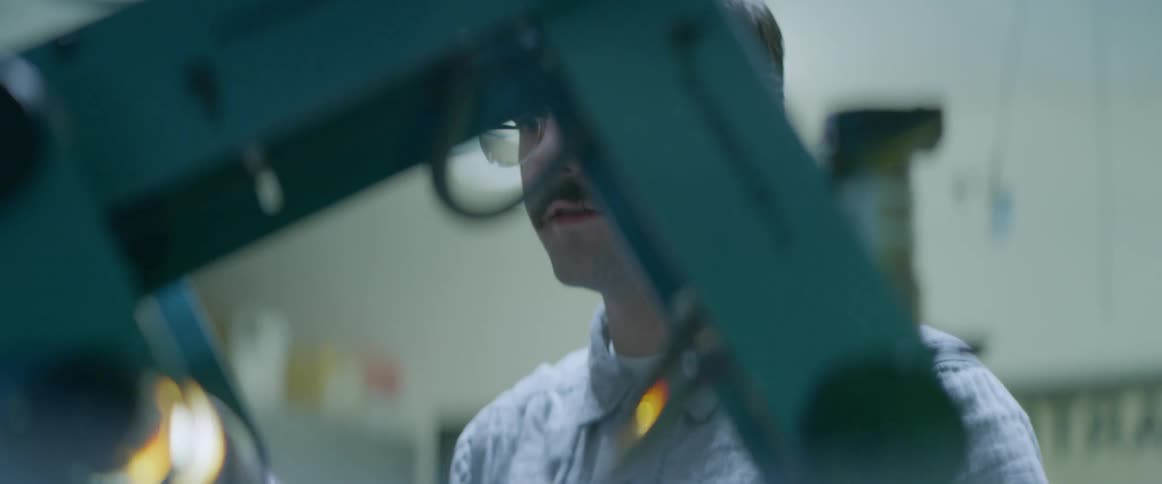 A man is working at a shop and using machines