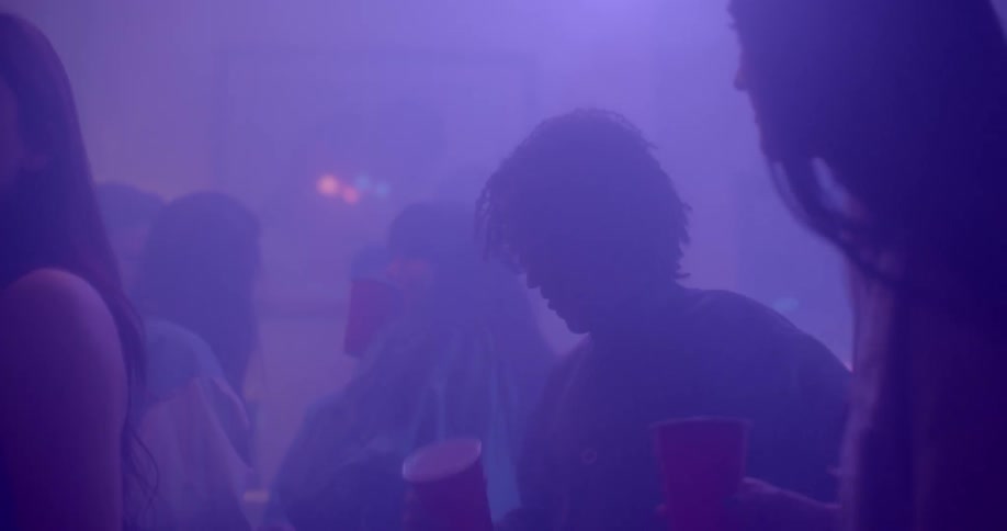 People dance and drink in a smoke filled club