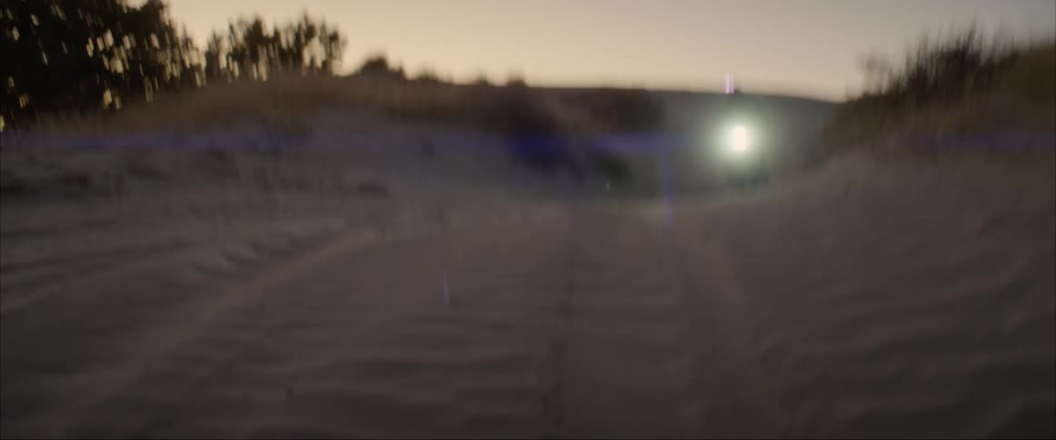 A man riding a motorcycle on a dirt road