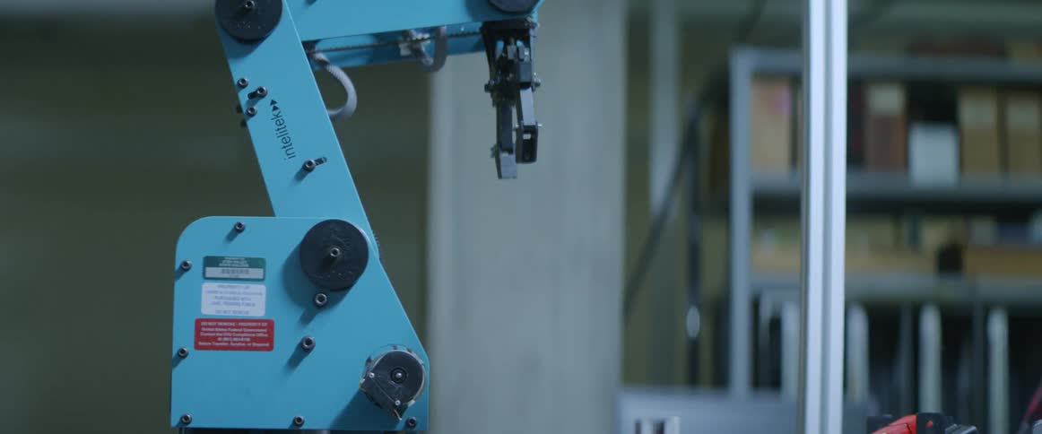 A robotic arm grabs a block