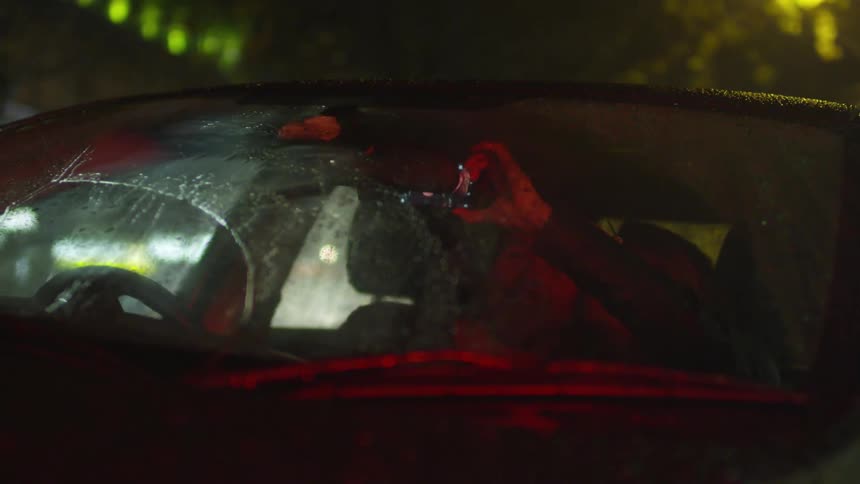 Two people take a selfie in a car at night