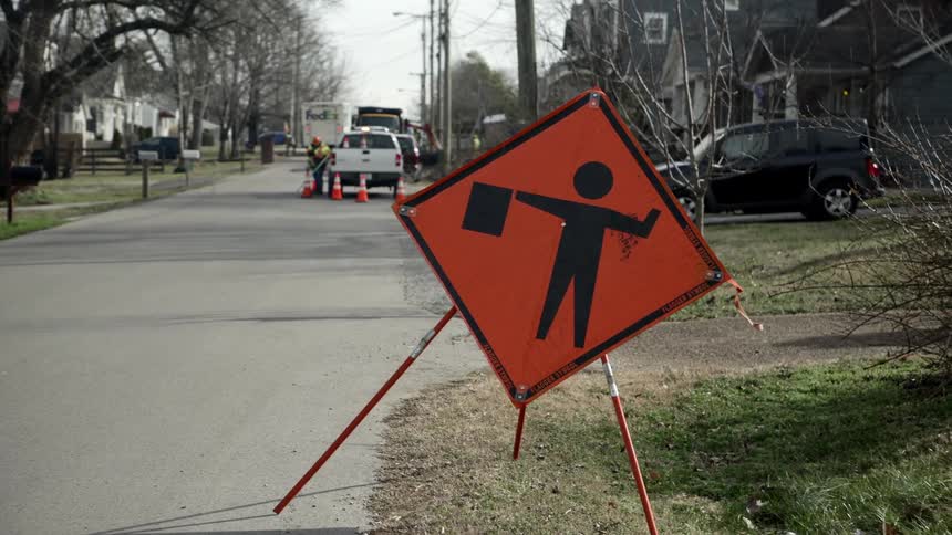 Maintenance workers work on the road in the neighbourhood
