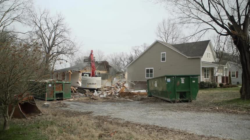 A tractor demolishing a house