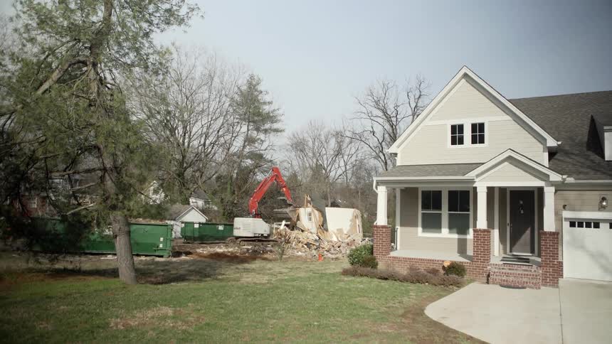 Construction equipment pushes demolished building debris