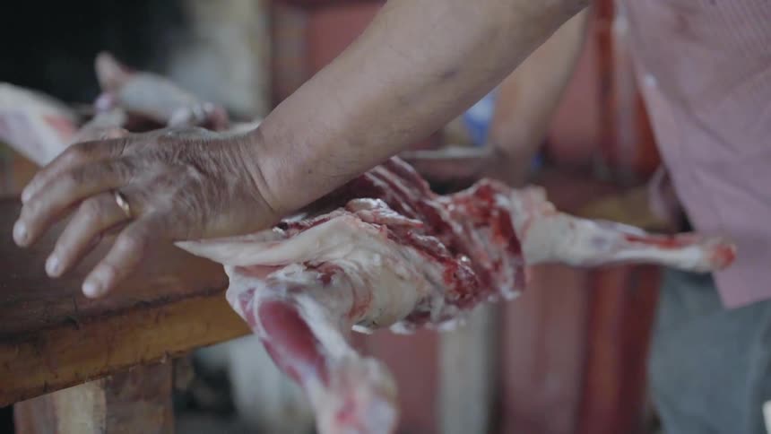 A butcher opens the legs