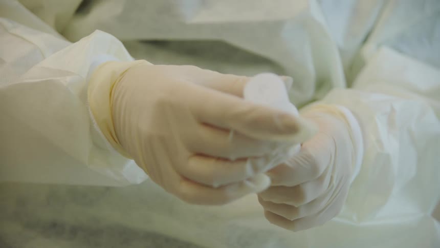 Medical technician places sample in another container