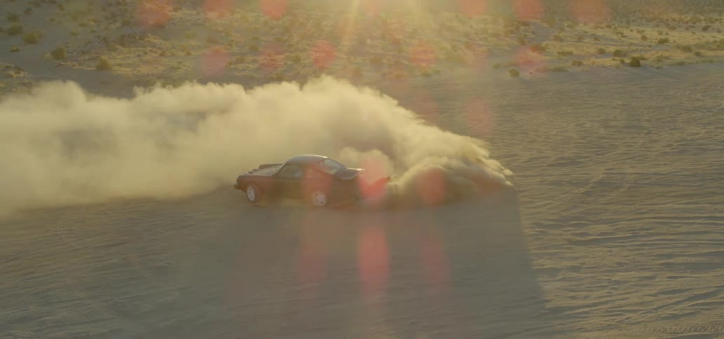A sports car doing donuts in the desert