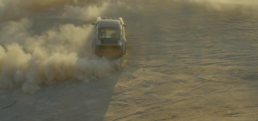 A car in the desert driving and skidding raising dust
