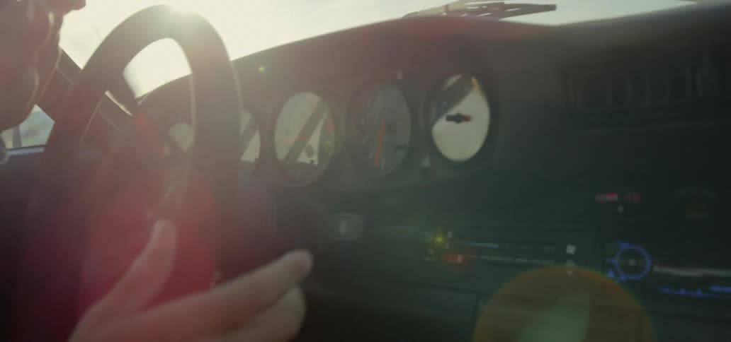 A man driving a car turning the steering wheel