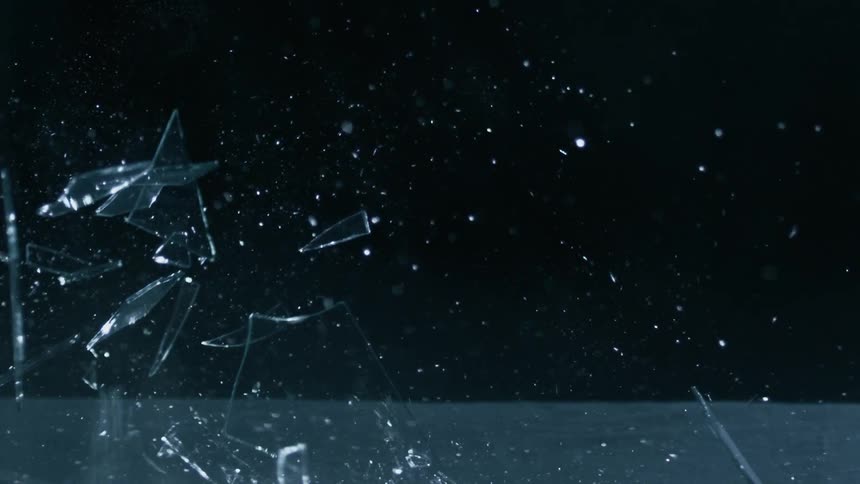A sheet of glass falling and shattering on the floor