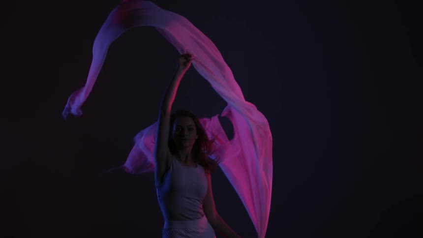 A woman dances with a white cloth