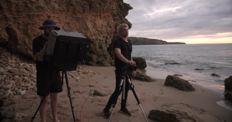 A photographer takes photos on a beach