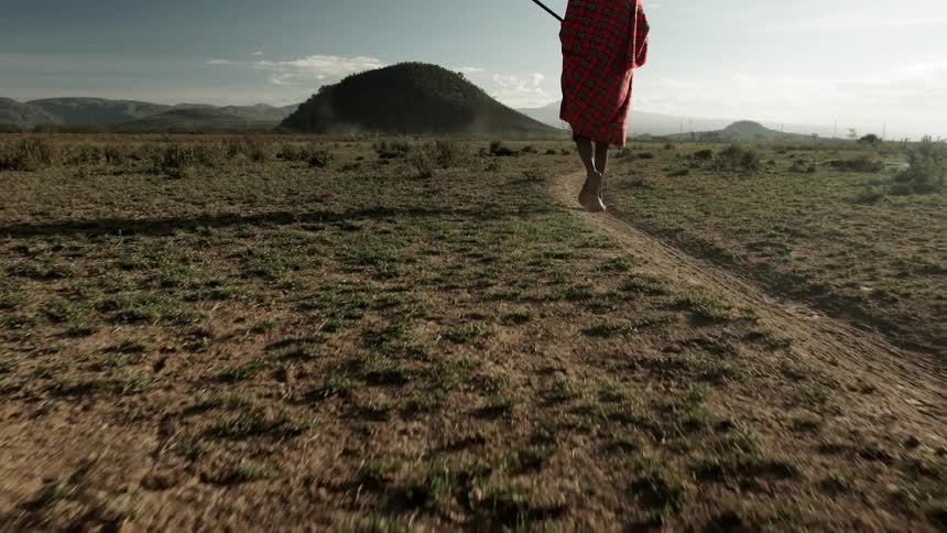 A person walks across a large field