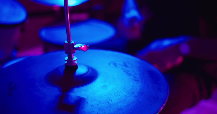 A man plays the drums on stage