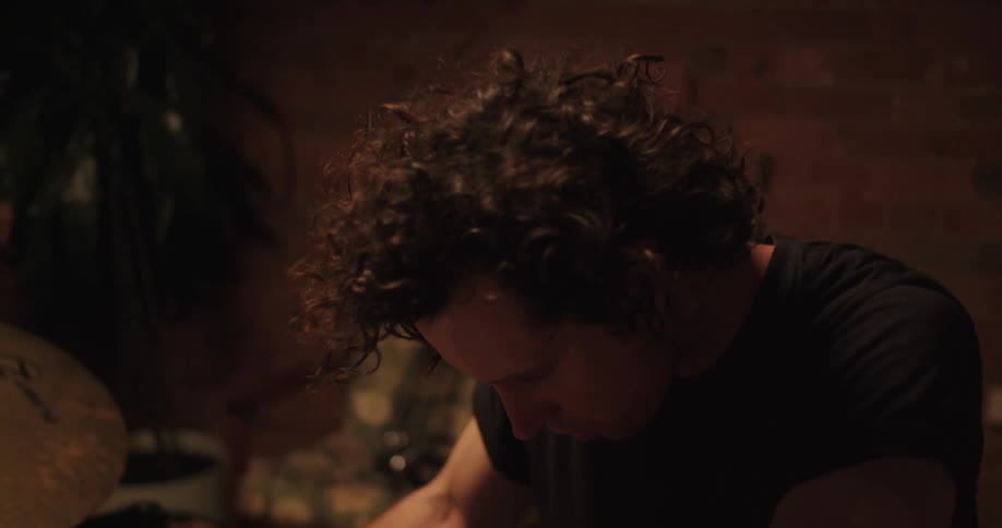 Drummer rests before beginning to play drums in the studio