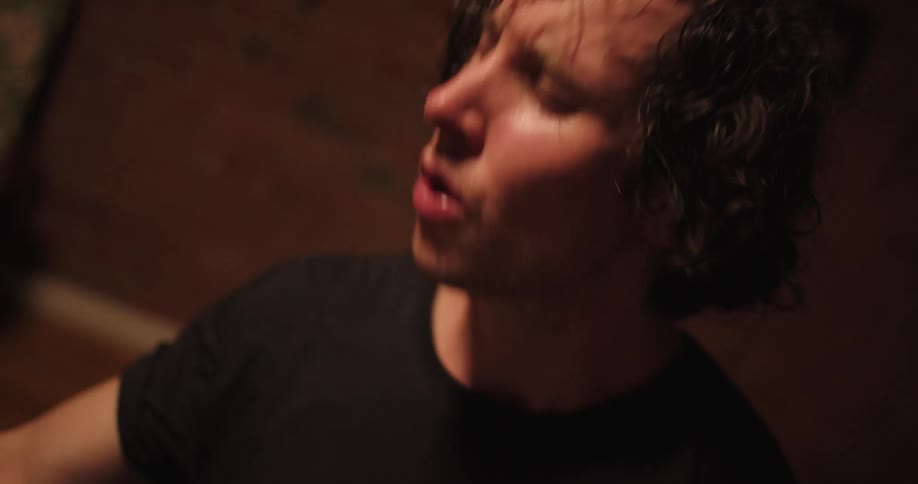 A drummers sweaty hair and face as he plays