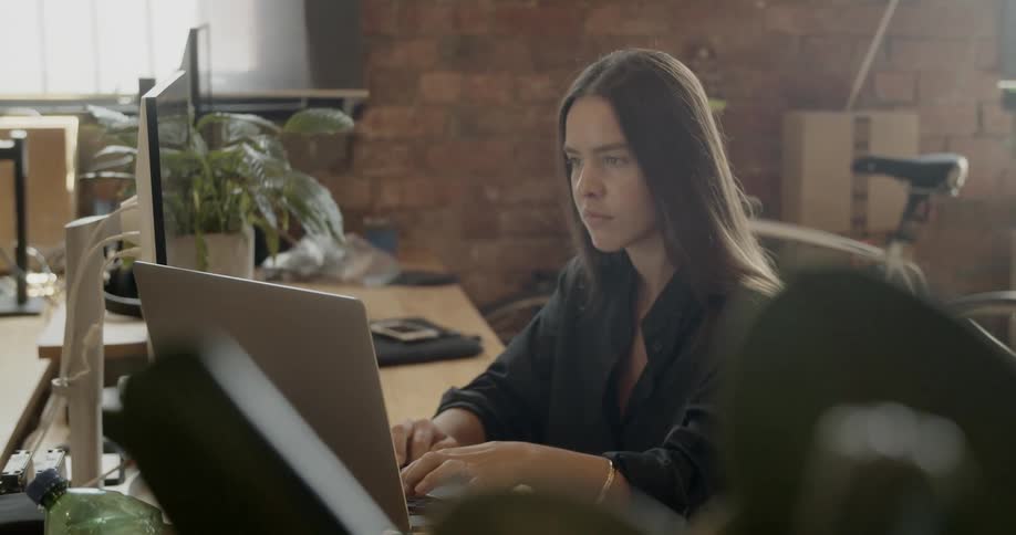 A woman works on a computer
