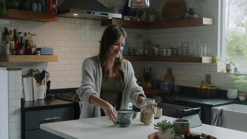 A woman is cooking in the kitchen